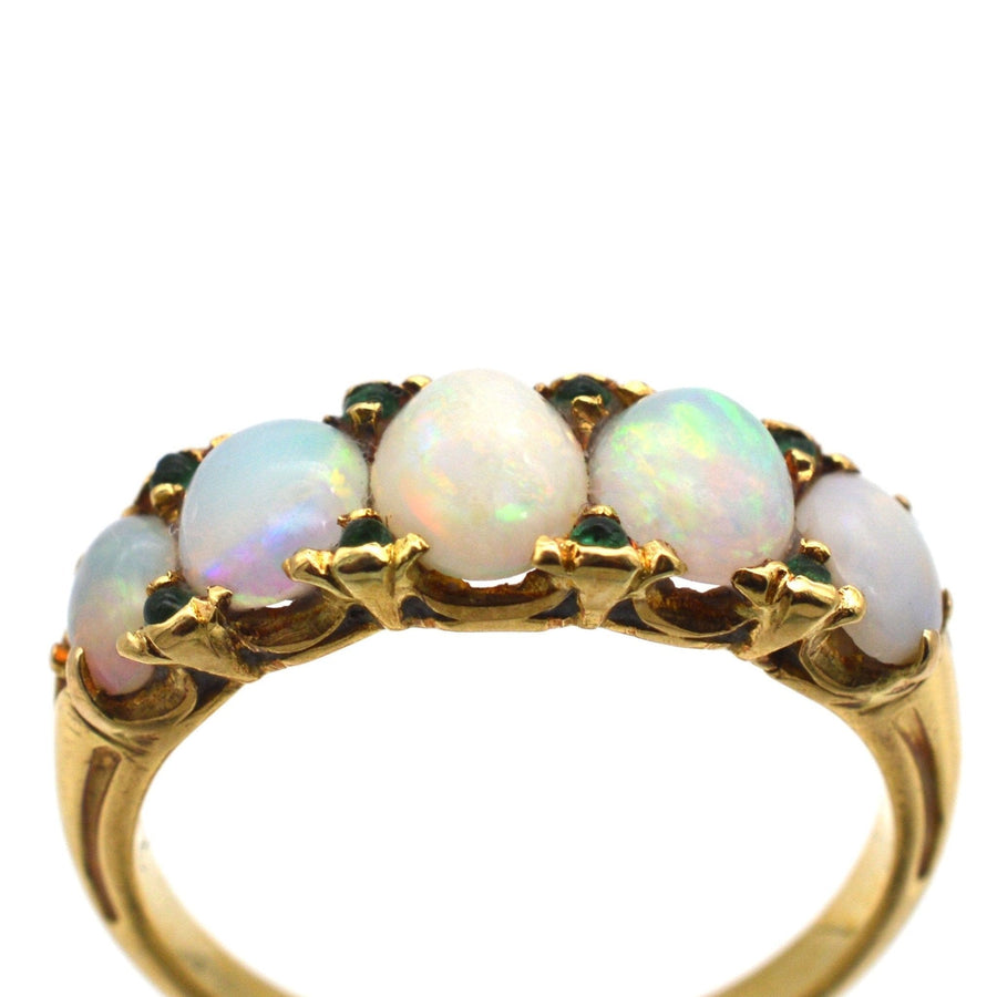 Victorian 18ct gold ring featuring opals and emeralds in a carved half hoop design, ideal for engagement.