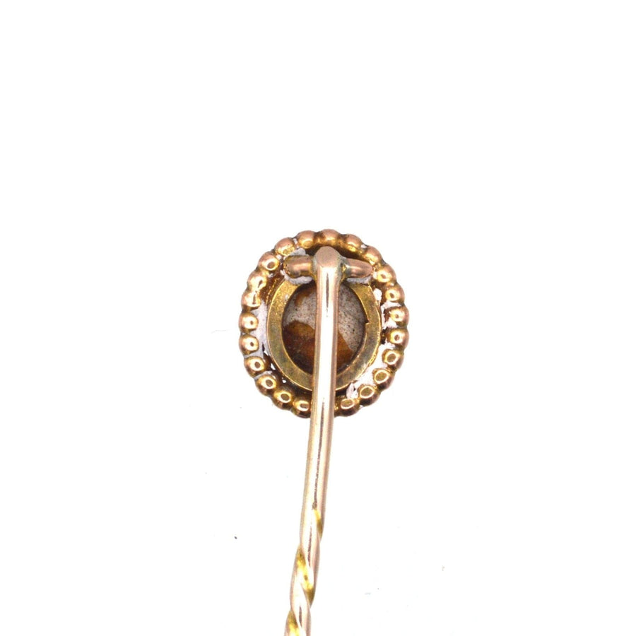 Victorian 9ct gold tie pin featuring a brown cat's eye shell center, vintage design from the 1880s-1890s.