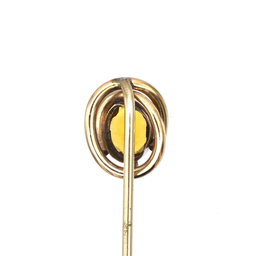 Victorian 9ct gold tie pin featuring a vibrant citrine paste in a swirling gold design.