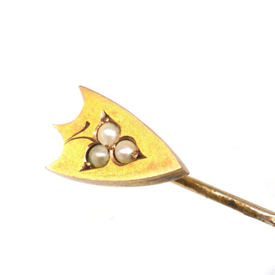 Victorian 9ct gold shield tie pin with three split pearls, featuring a classic heraldic design.