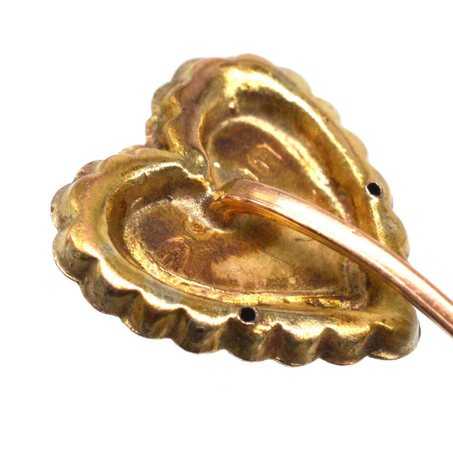 Close-up of Victorian 9ct gold heart tie pin showcasing intricate two-tone gold overlay and hallmarks.