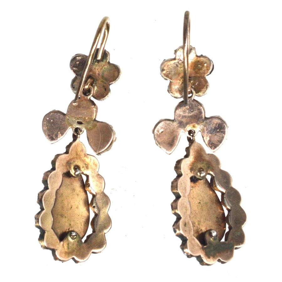 Antique Victorian gold earrings with rose-cut garnets, showcasing unique floral design and vintage elegance.