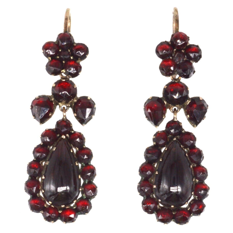 Victorian gold bohemian garnet earrings featuring rose-cut gemstones from the 1860s with deep red hues.