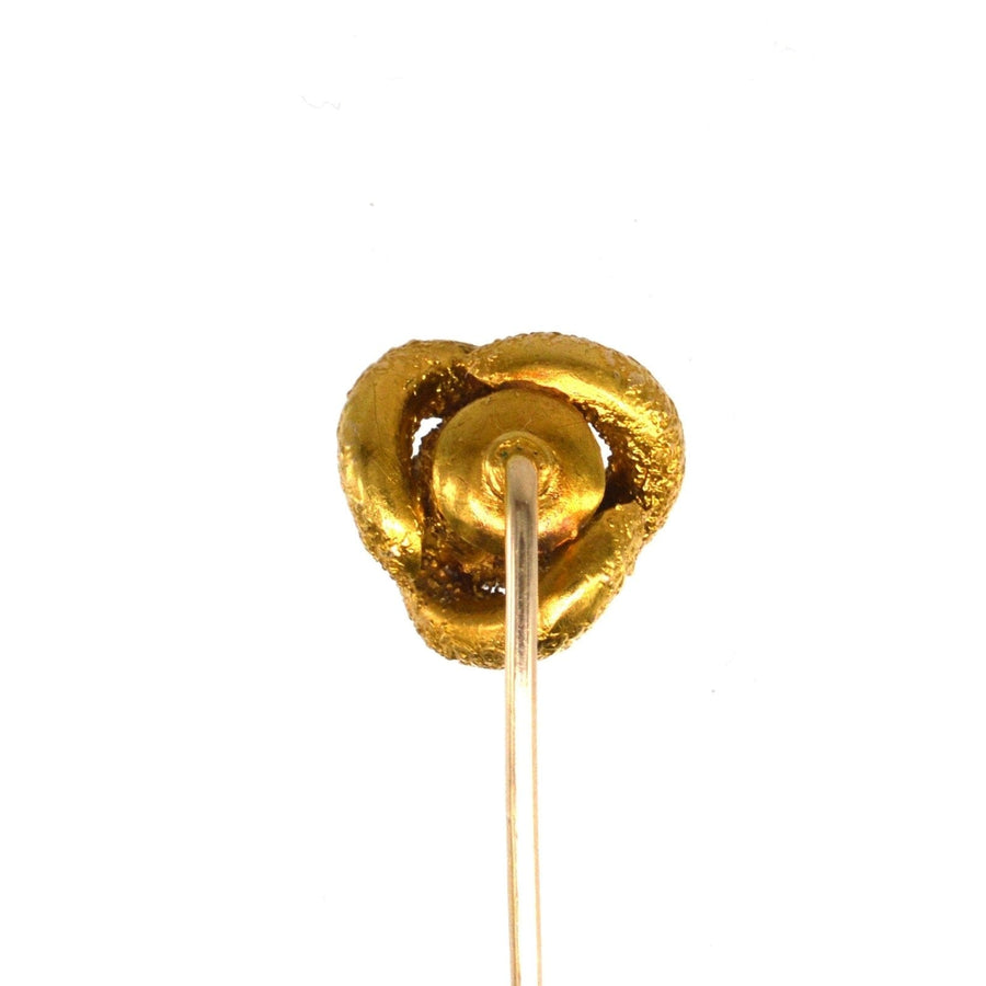 Victorian gold knot tie pin exhibiting a textured design, symbolizing love and support.