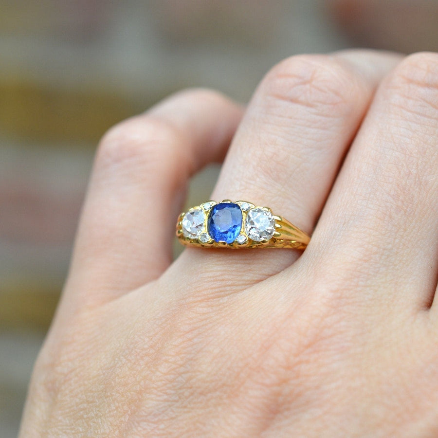 Victorian-style 18ct gold ring featuring a cornflower blue sapphire and two old mine cut diamonds.