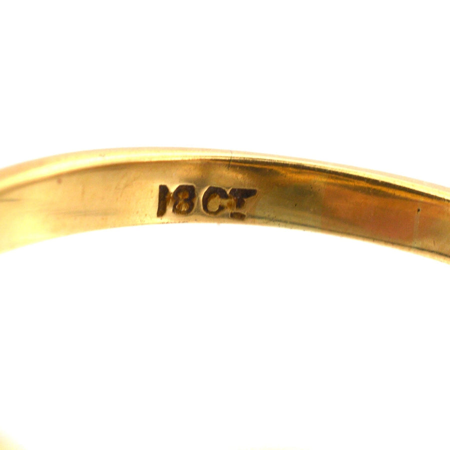 Close-up of the hallmark showing 18ct gold on a vintage ring, showcasing quality craftsmanship.