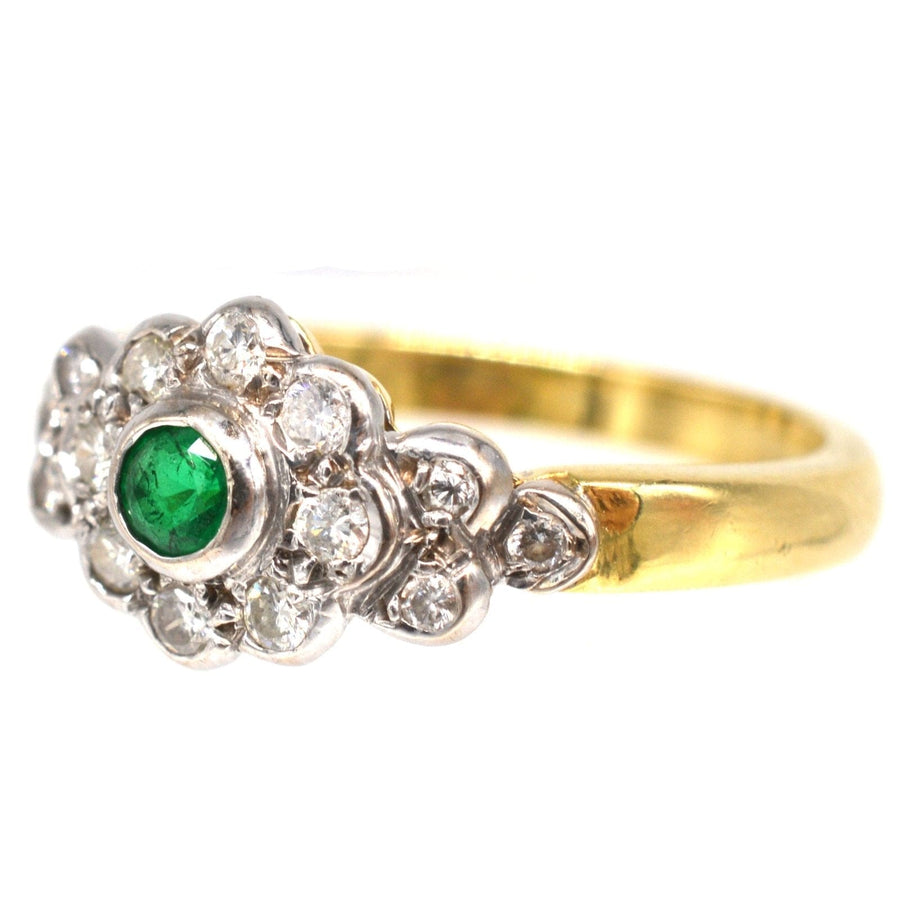 Vintage 18ct gold emerald and diamond cluster ring with sparkling diamonds and rich green center gem.