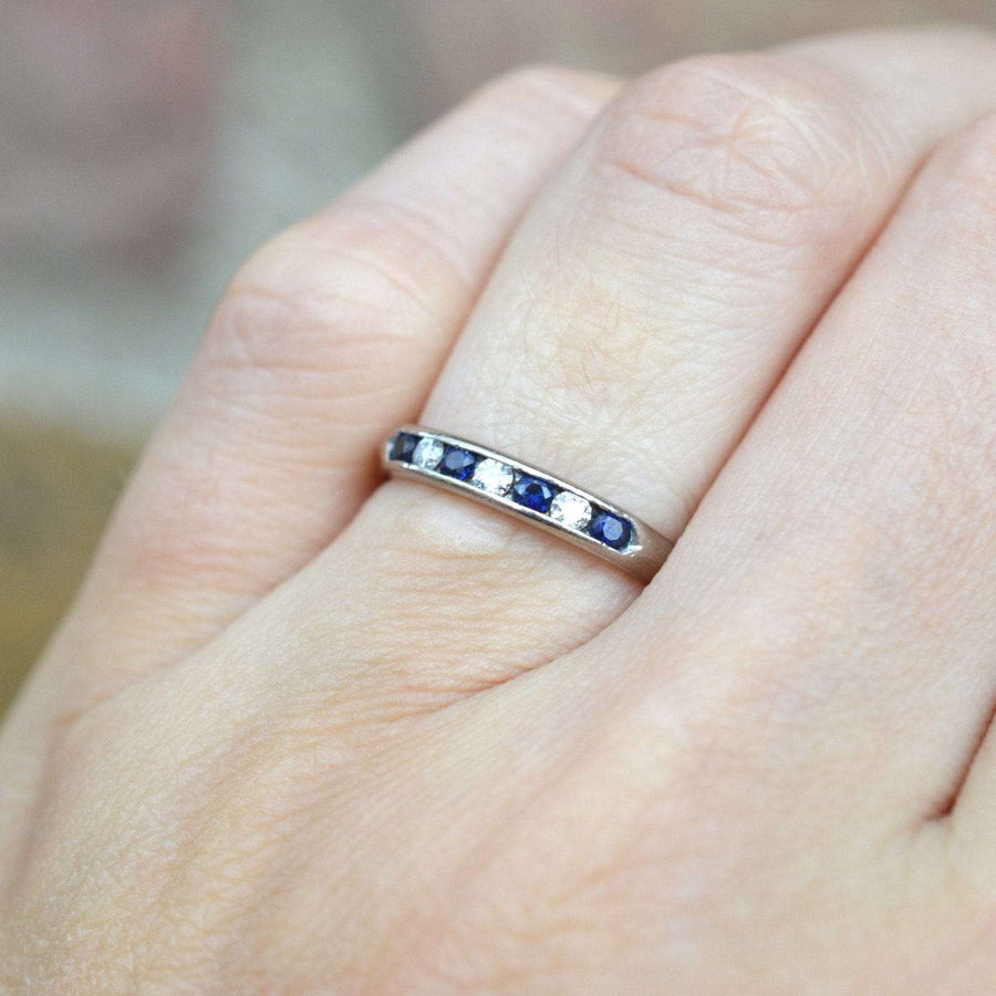 Vintage 18ct white gold half eternity ring featuring sapphires and diamonds, dating from the 1960s-70s.