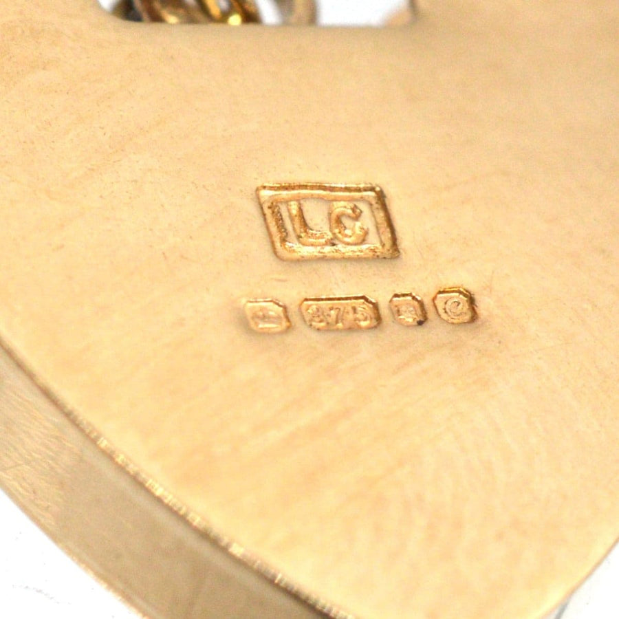 Hallmark engraving on a 9ct gold heart padlock from a vintage curb bracelet.