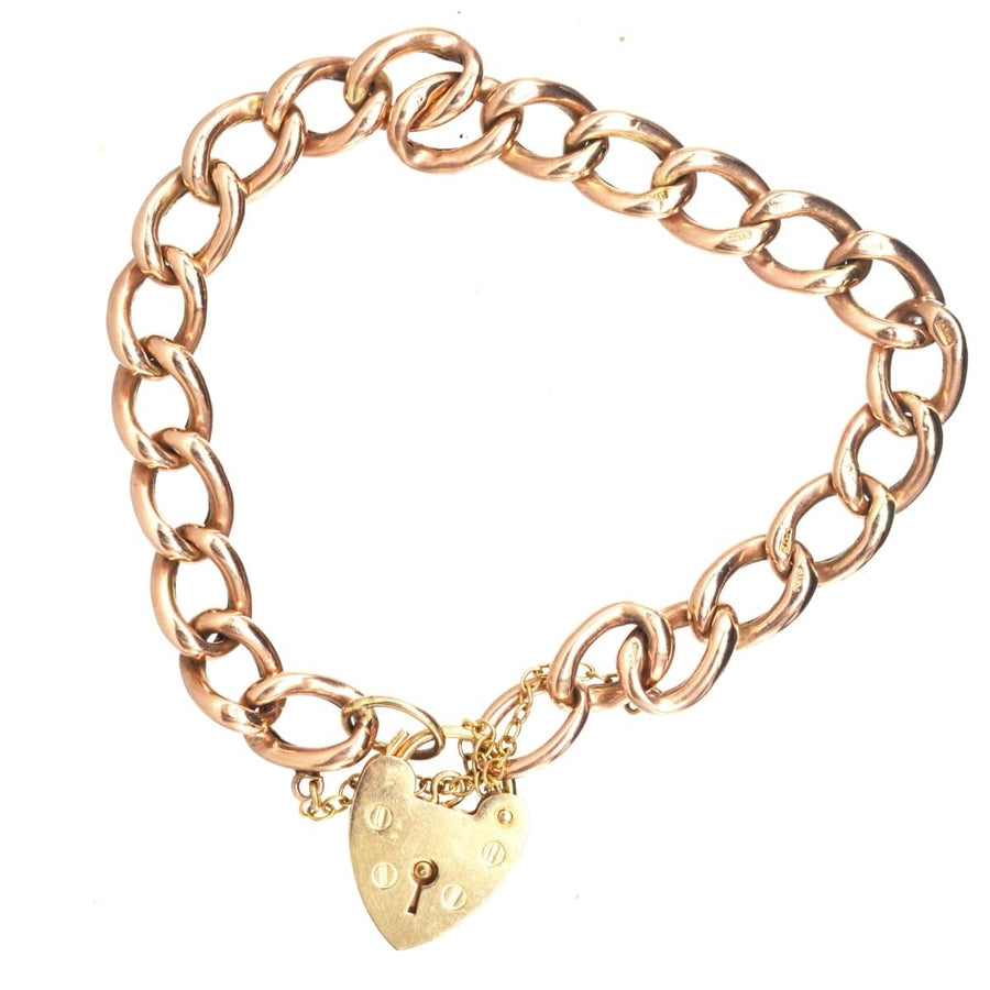 Vintage 9ct gold curb bracelet with heart lock, stylish and functional for everyday wear.