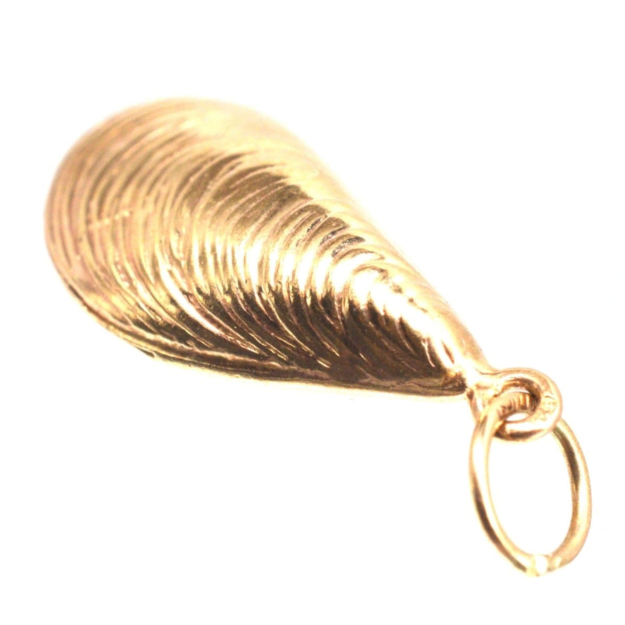9ct gold mussel shell charm pendant crafted in London, ideal for jewelry lovers and sea enthusiasts.