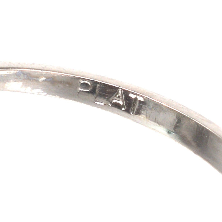 Close-up of the interior engraving on a vintage platinum ring showing 'PLAT' hallmark for authenticity.