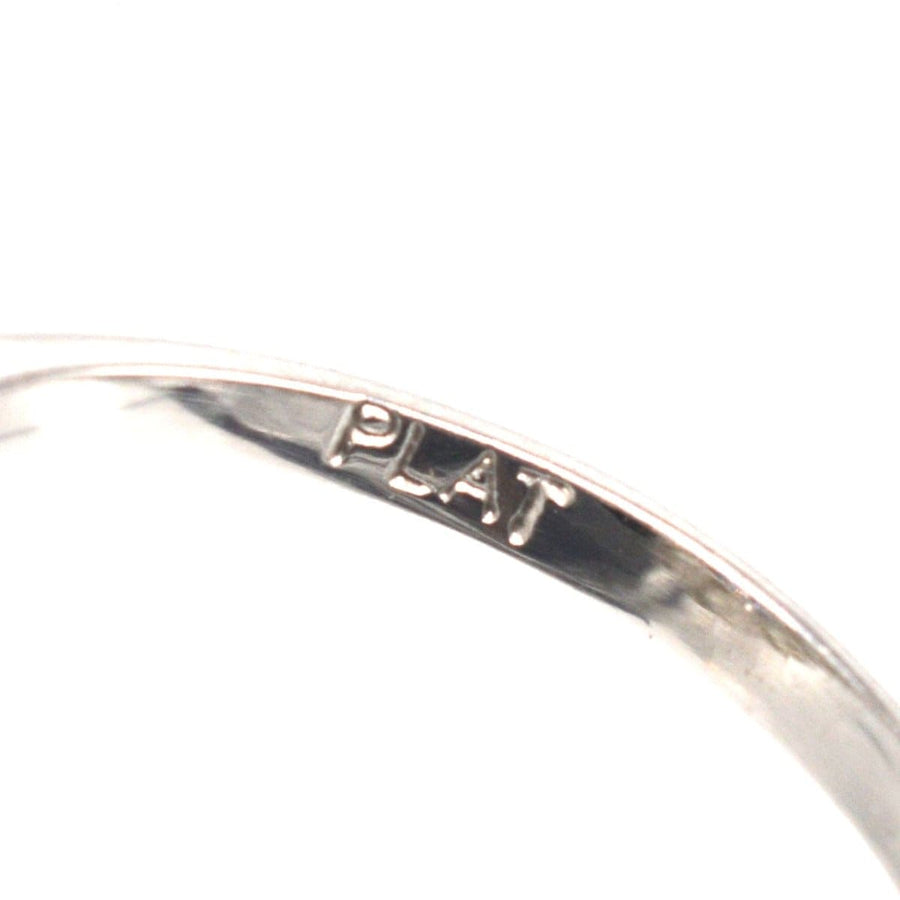 Close-up of a vintage platinum ring showing the 'PLAT' hallmark inscription.