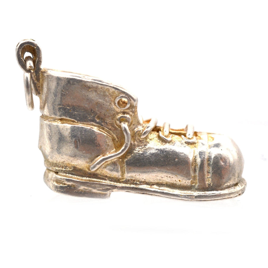Vintage silver boot pendant charm from the 1970s, featuring detailed lacing and a playful design.