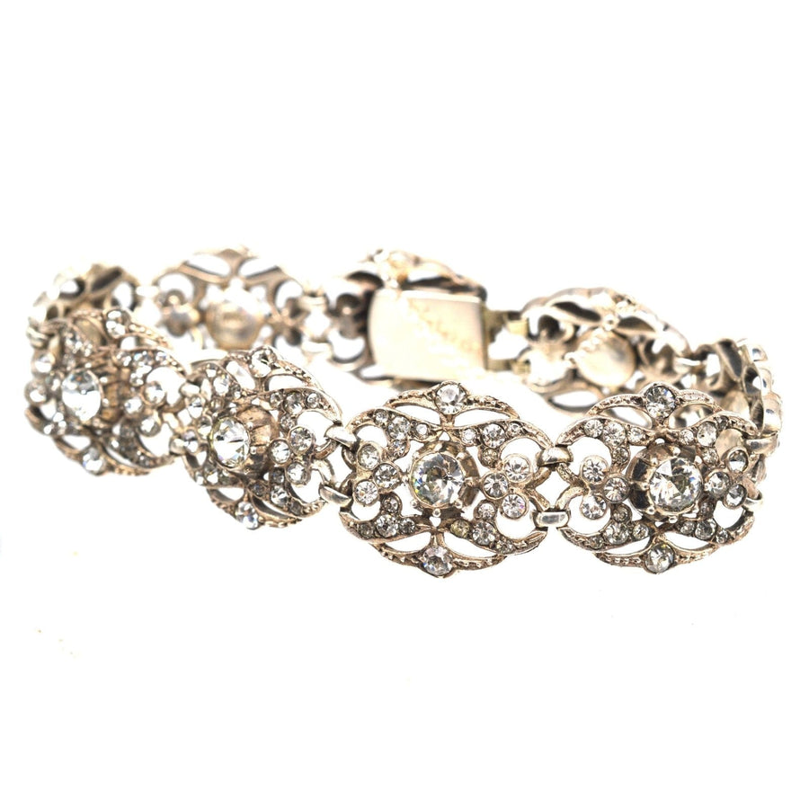 Elegant wide Edwardian silver paste bracelet featuring large foliage-like plaques and sparkling stones.
